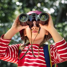 kid using binoculars
