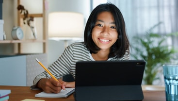 teen smiling while studying