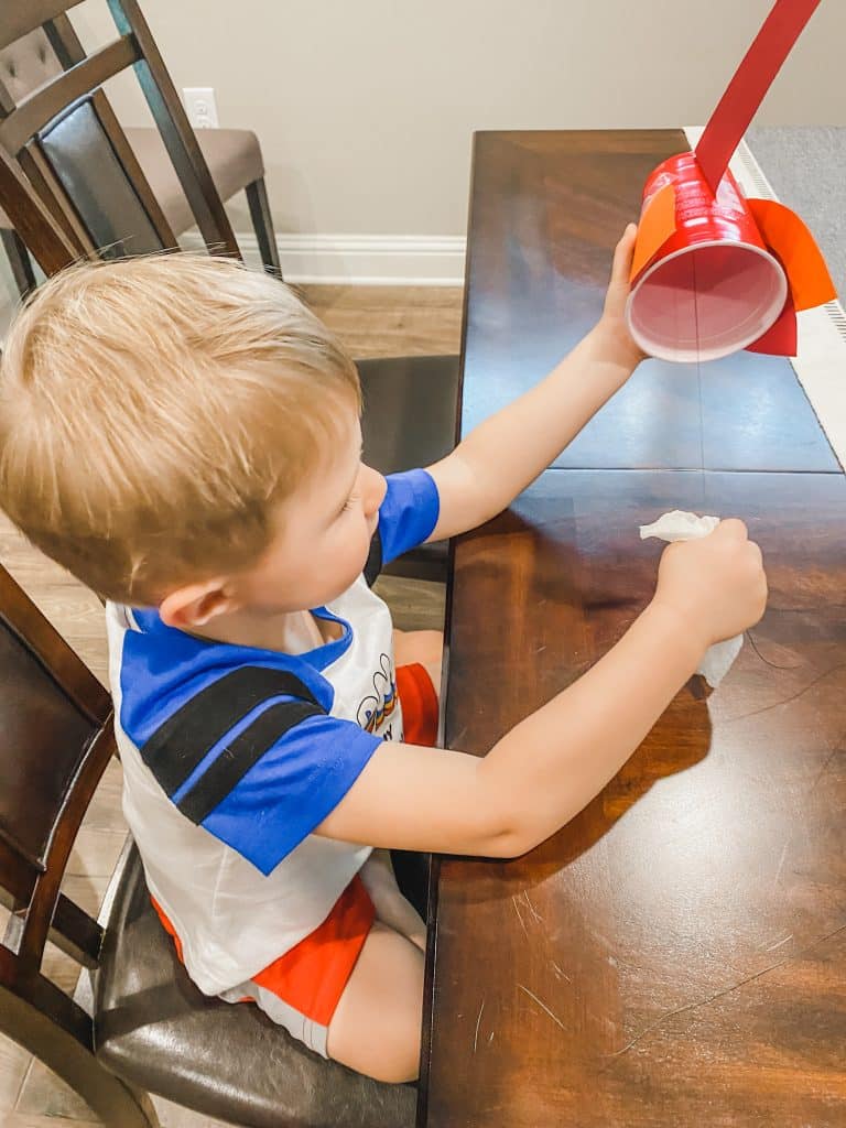 Gobbling Turkey Craft - child playing with finished craft
