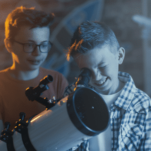 kids looking through a telescope