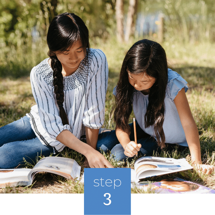Two girls learning from Apologia curriculum
