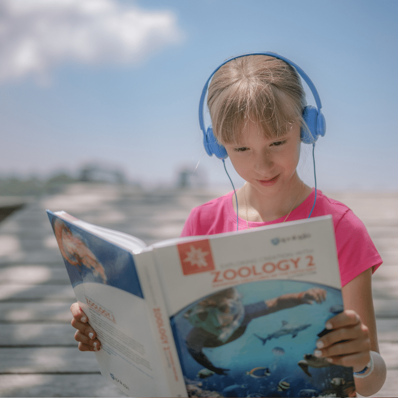 Student listening to an audiobook of Exploring Creation with Zoology 2 from Apologia