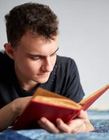 teenage boy reading literature