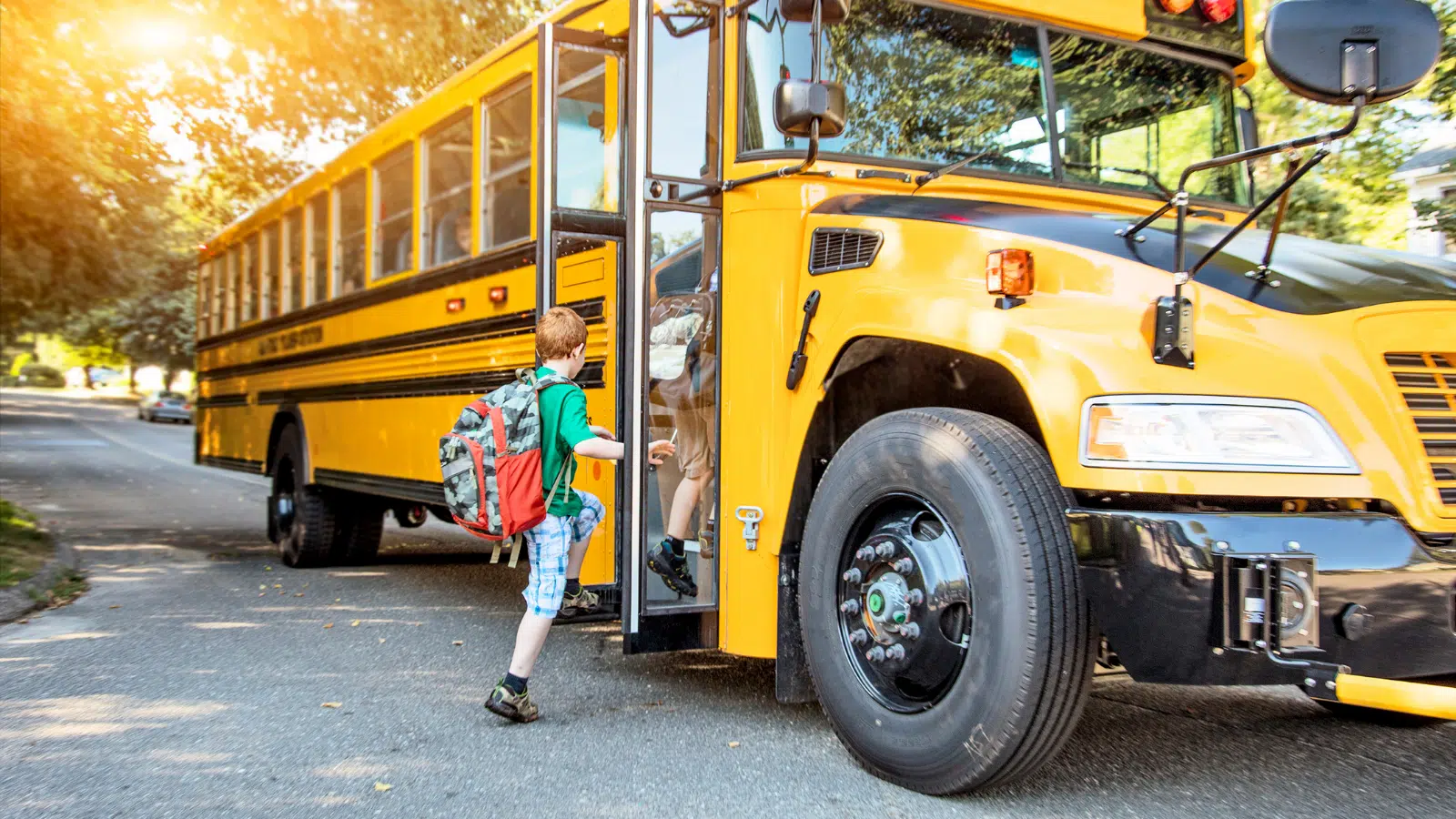 kid getting on schoolbus