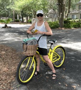 Rachael Carman on yellow bicycle