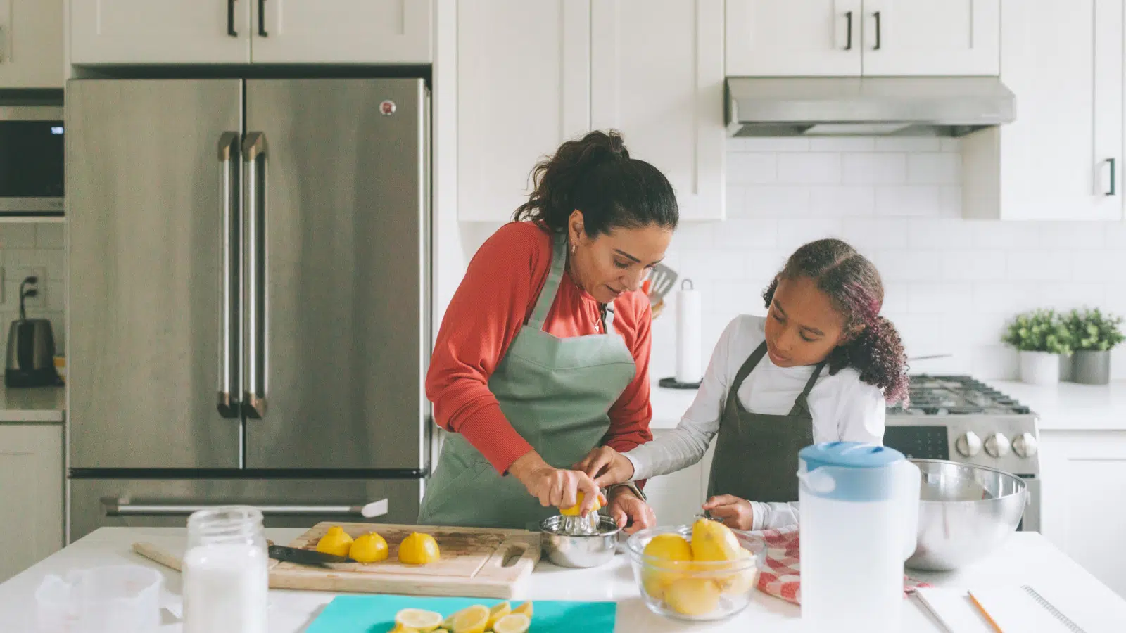 Mom and daughter cooking in kitchen together